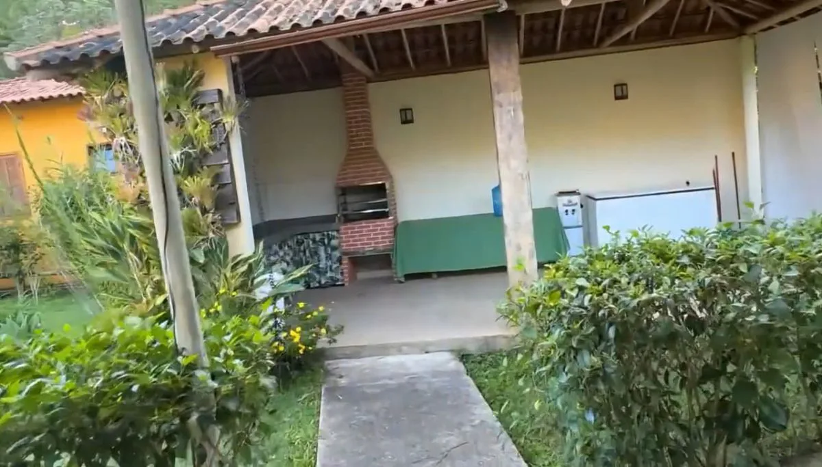 Quiosque com churrasqueira cercado de plantas